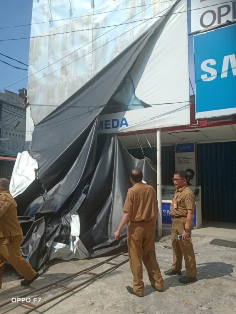 Tak Bayar Pajak, Belasan Papan Reklame Dibongkar 1 DIBUKA— Kepala Bapenda Al Amin dan Petugas Bapenda Kota Padang membuka baliho yang dipastikan belum membayar pajak di sejumlah titik di Kota Padang.