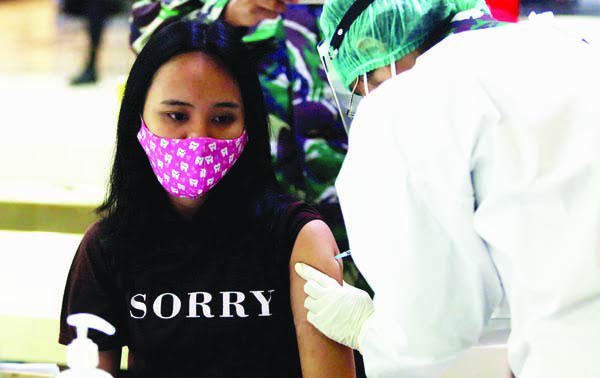 VAKSIN—Terlihat petuigas tim Dinkes sedang melakukan suntik vaksin Covid-19 kepada pedagang di Blok 16 baru baru ini.