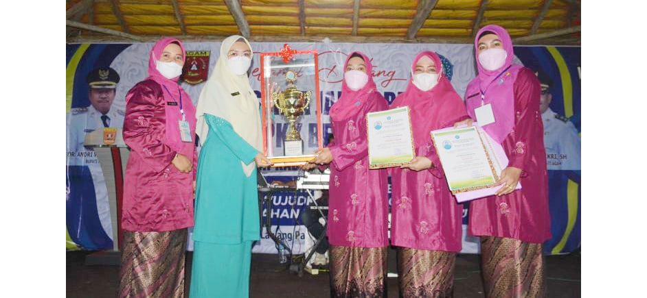JUARA UMUM Ketua TP PKK Kecamatan Lubuk Basung Ny Lin Harmezi foto bersama saat memegang Tropi Juara Umum Jambore Kader P11KK Berprestasi 2021