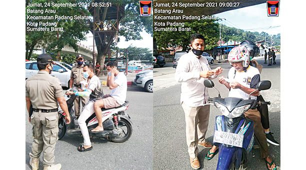 BAGIKAN MASKER— Aparat Kelurahan Batang Arau bersama Satpol PP membagikan masker kepada pengendara di kawasan Jembatan Siti Nurbaya, Jumat (24/9).