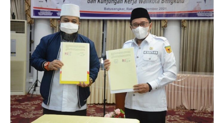 KERJA SAMA— Kedua kepala daerah memperlihatkan kertas kerja sama.