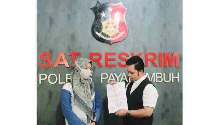 MELAPOR— Korban FB (39) dan pengacaranya memperlihatkan bukti laporan ke Polres Payakumbuh terkait dugaan pencemaran nama baik dengan terlapor owner arisan online.