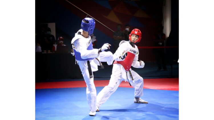 LAWAN TUAN RUMAH— Marstio Embrian Hidayatullah (kanan) saat menghadapi taekwondoin tuan rumah Cristian Ronaldo, Jumat (1/10) di GOR Politeknik Penerbangan Kayu Batu, Kota Jayapura.