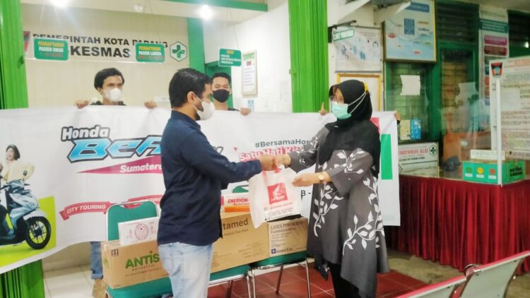 Menara Agung Gelar Honda BeAT Day Satu Hati Kita Peduli 1 BERIKAN BANTUAN-Perwakilan Menara Agung memberikan bantuan paket kesehatan kepada tenaga kesehatan di Puskesmas Air Tawar, disela kegiatan Honda BeAT Day Satu Hati Kita Peduli.