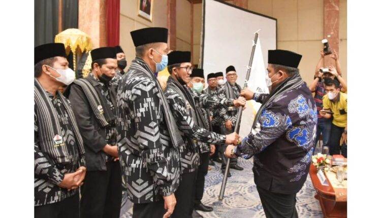 KUKUHKAN—Bupati Padangpariaman Suhatri Bur sedang mengukuhkan pengurus PKDP Riau yang baru.