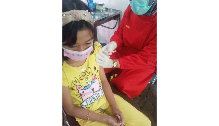 VAKSINASI ANAK— Murid kelas III SDN 05 Padang Pasir, Latifa melakukan suntik vaksin dosis I, di Puskesmas Alai, kemarin. Vaksinasi Covid-19 merupakan salah satu syarat bagi anak Sekolah Dasar (SD) di Kota Padang untuk bisa mengikuti PTM di sekolah.