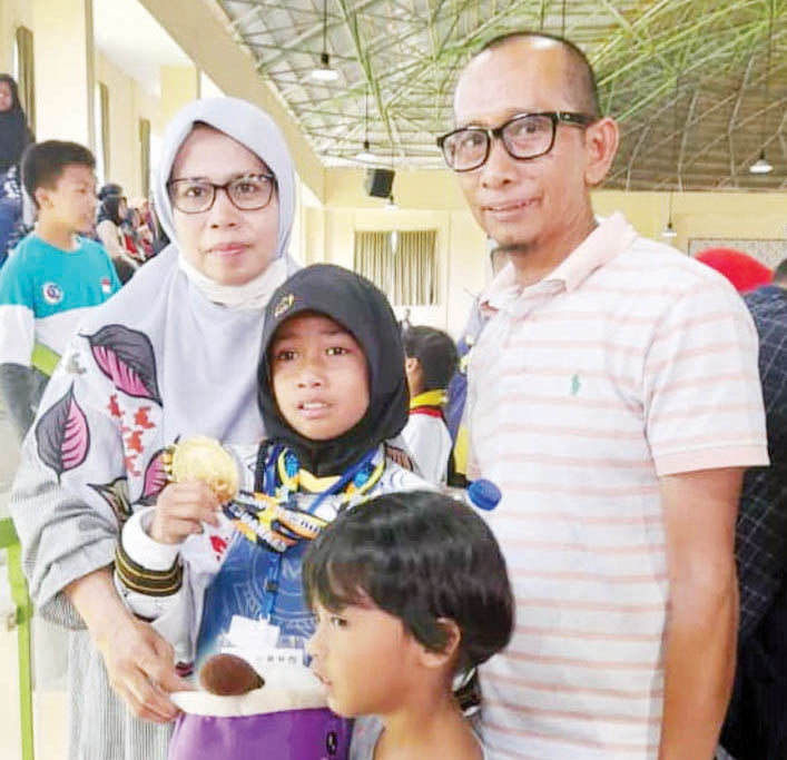 BERSAMA ORANGTUA--Fahira Ataya Gusman (10) siswa kelas 4 SDIT Cahaya Hati Bukittinggi mendulang emas di turnamen Taekwondo Jam Gadang Open 1 Kota Bukittinggi.