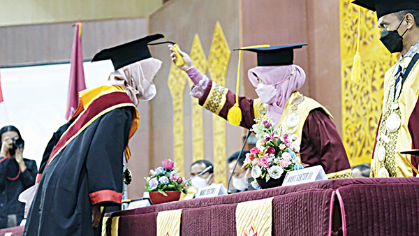 Rektor UIN IB Padang Prof Martin Kustati, tengah memindahkan jambul kepada wisudawati.