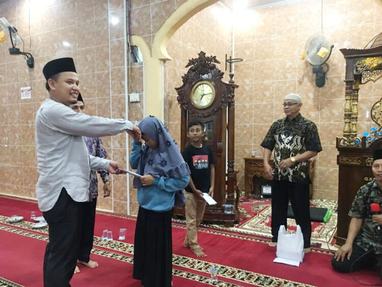 SANTUNAN— Wakil Ketua DPRD Kota Solok Bayu Kharisma menyerahkan santunan kepada anak yatim.