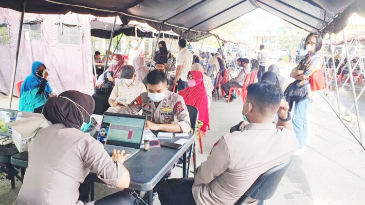 GERAI VAKSIN-Petugas medis melayani masyarakat yang ingin vaksin di gerai vaksin di Polda Sumbar.