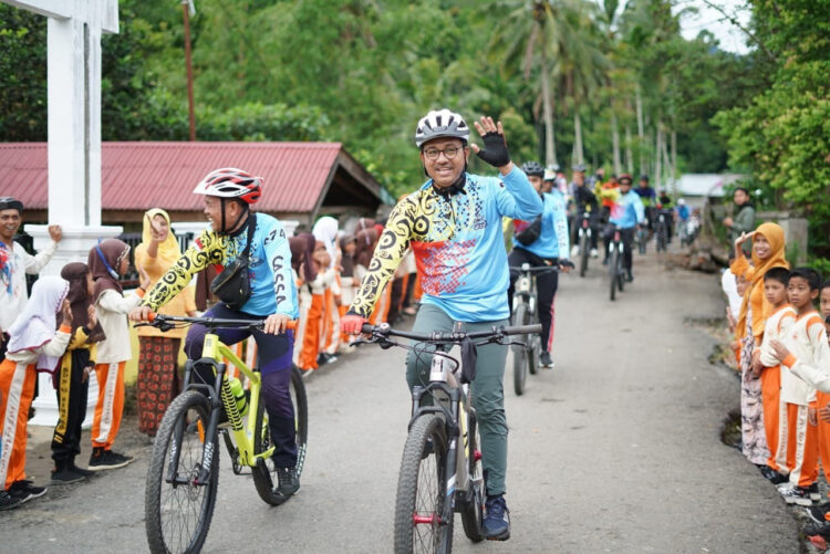 GOWES SIMANCUANG— Bupati Solsel Khairunas gowes ke Simancuang dalam menghadiri tradisi membantai kabau godang pertanda awal turun ke sawah.