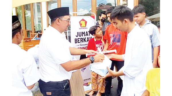 JUMAT BERKAH— Wakil Bendahara DPD Gerindra Sumbar Dafrawira De Hansen menyerahkan nasi kotak Jumat Berkah dari Andre Rosiade di Masjid Al Ikhlas Kompleks Kehakiman, Lubukbegalung.