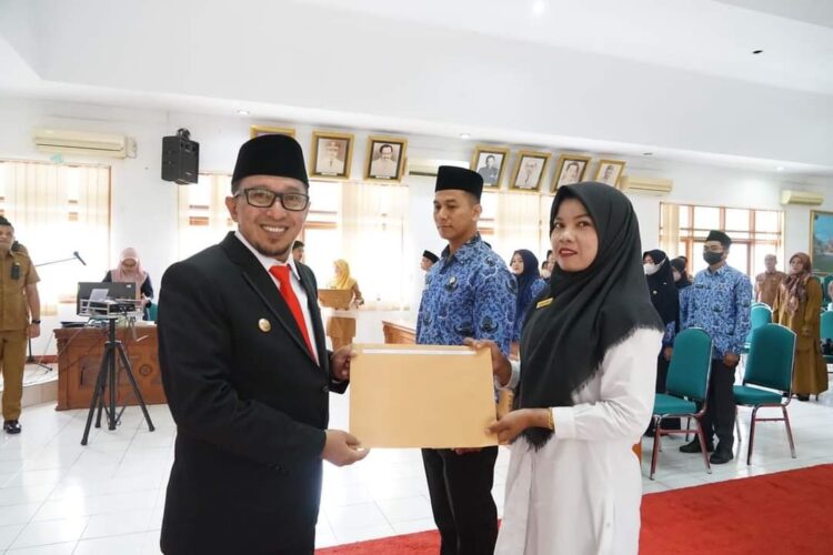 14 PNS Fungsional dan 42 PPPK Dilantik dan Diambil Sumpah Jabatan di Tanah Datar 1 SERAHKAN SK— Bupati Eka Putra serahkan SK pada salah seorang perwakilan PNS Fungsional dan PPPK.