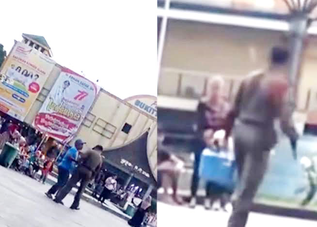 TANGKAPAN LAYAR—Tangkapan layar video yang memperlihatkan seorang oknum Satpol PP Bukittinggi yang melakukan pemaksaan terhadap pedagang di sekitaran Jam Gadang.
