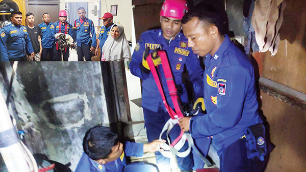 SELAMATKAN KUCING— Petugas Damkar Kota Padang melakukan aksi heroik dengan menyelamatkan seekor kucing yang terjebak sumur, Selasa (31/1) malam, di kawasan Bypass Koto Panjang Ikua Koto (KPIK), Kecamatan Kototangah.