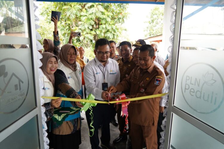 PERESMIAN— Kepala Dinas Lingkungan Hidup Kota Padang Ir H Mairizon gunting pita pada saat peresmian bank sampah di Pasie Sabalah, Kecamatan Koto Tangah.