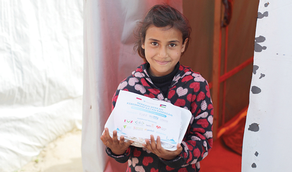 HIDANGAN BERBUKA PUASA— Seorang anak Palestina menerima bantuan hidangan untuk berbuka puasa dari ParagonCorp.