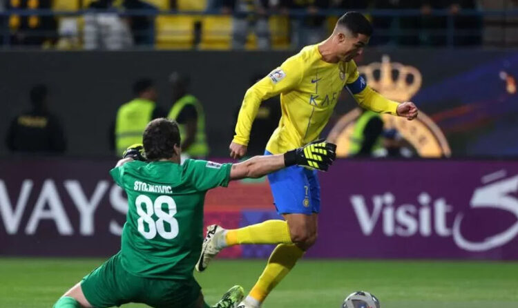 Al-Nassr Menang 4-2 Lawan Al-Ittihad, Ronaldo Memecahkan Rekor Gol Liga Pro Saudi di Laga Terakhir 1 LEWATI KIPER— Penyerang Nassr asal Portugal Cristiano Ronaldo (kanan) berlari dengan bola melewati kiper Fayha asal Serbia Vladimir Stojkovic.