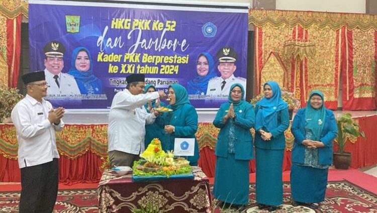 PERINGATAN HGK PKK—Bupati Padangpariaman Suhatri Bur memberikan suapan tumpeng kepada Ketua TP-PKK Padangpariaman, Ny. Yusrita Suhatri Bur saat peringatan HGK PKK ke-52.