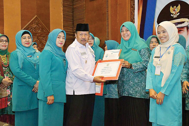BERIKAN PENGHARGAAN— Bupati Agam Andri Warman didampingi Ketua TP PKK Agam Ny Yenni Andri Warman menyerahkan penghargaan Adhi Bakti Madya PKK 15 tahun dan penetapan pemenang lomba gerakan PKK tahun 2023 tingkat Kabupaten, Rabu (10/7).