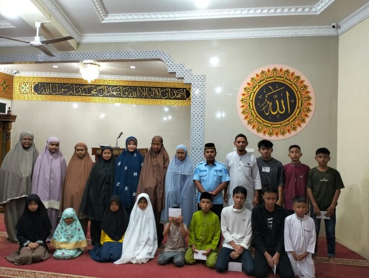 FOTO BERSAMA—Sekretaris Masjid, Darmanto, didampingi Bendahara, Maryulis Max, foto bersama dengan anak yatim usai penyerahan santunan, Selasa (16/7).