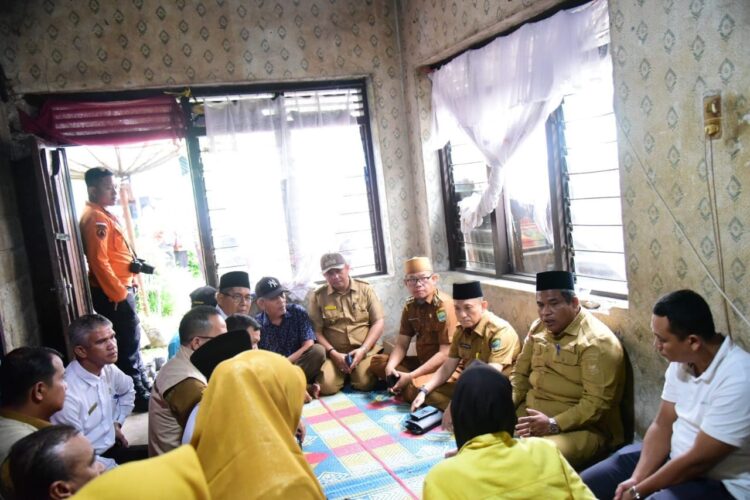 MELAYAT KE RUMAH DUKA— Bupati Padangpariaman Suhatri Bur saat mengunjungi rumah almarhumah penjual gorengan, Nia Kurnia Sari (18) warga Korong Pasa Surau Nagari Guguak Kecamatan 2x11 Kayutanam, kemarin.