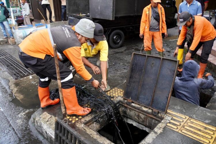 Drainase Selokan di Kawasan Pasar Pusat Dibersihkan 1 NORMALISASI—Wakil Wali Kota, Allex Saputra bersama Pasukan Oranye (petugas kebersihan), Satpol PP Damkar, BPBD, dan PDAM melakukan aksi normalisasi selokan dan drainase di kawasan Pasar Pusat dan sekitar Jalan Imam Bonjol, Kamis (13/3).