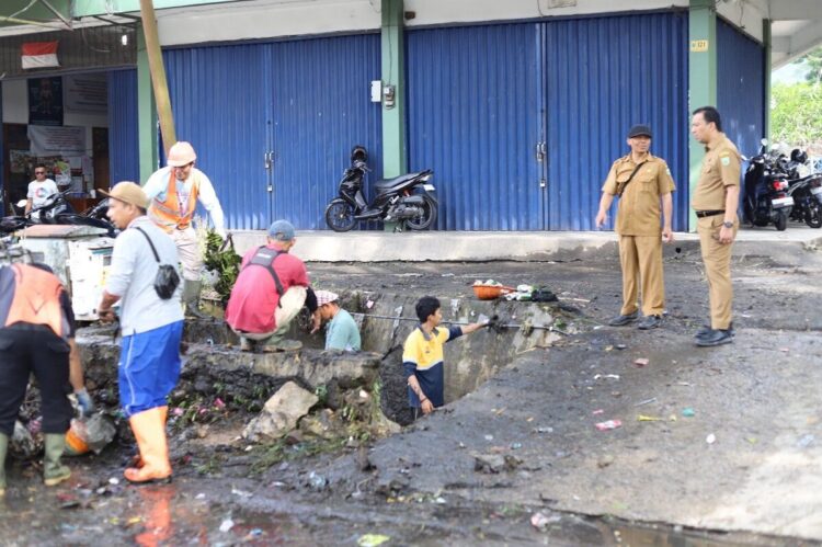 BERSIHKAN DRAINASE— Tim Gabungan langsung melakukan eksekusi membersihkan saluran drainase sepanjang jalur Kelurahan Bukit Surungan, Senin (16/6).