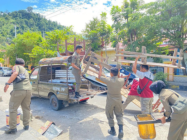 Pol PP dan Damkar Pessel, Tertibkan Lapak PKL di Taman Spora Painan 1 TERTIBKAN LAPAK PKL— Anggota Sat Pol PP dan Damkar Pessel, mengamankan sejumlah lapak dan barang dangan milik PKL di kawasan Taman Spora Painan.