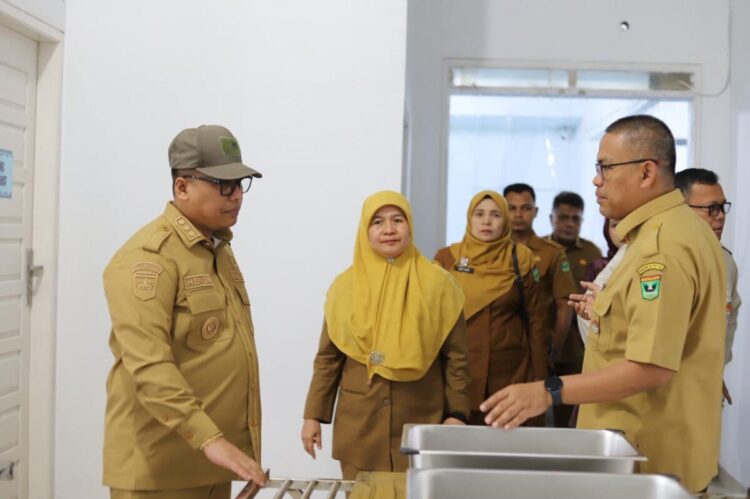 Sekdaprov Sumbar Arry Yuswandi, Tinjau Terminal Busur dan Fasilitas Produksi MBG di Padang Panjang 1 JELASKAN—Wali Kota Padang Panjang Hendri Arnis saat menjelakan pada Sekretaris Daerah Provinsi (Sekdaprov) Sumatera Barat, Arry Yuswandi tentang fasilitas produksi program Makan Bergizi Gratis (MBG).