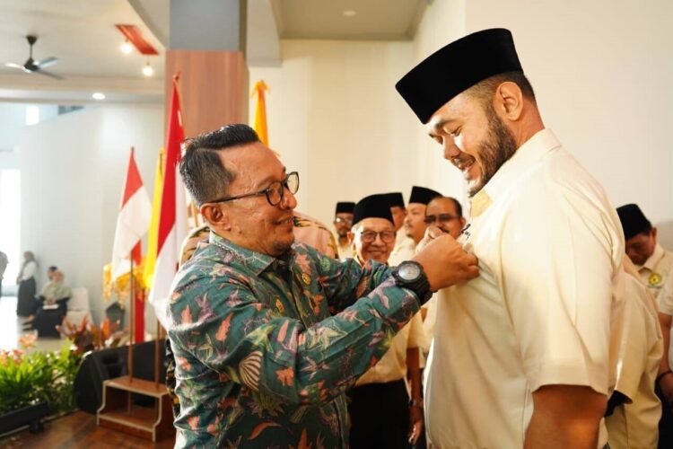 Fadly Amran Dikukuhkan Sebagai Ketum IKTD Sumbar, Eka Putra Titipkan Perantau Asal Tanah Datar 1 SEMATKAN—Bupati Tanah Datar Eka Putra sematkan logo IKTD saat dikukuhkan menjadi Ketua Umum Ikatan Keluarga Tanah Datar (IKTD) Provinsi Sumatera Barat Periode 2025-2029, Minggu (21/9) di gedung Bagindo Aziz Chan Youth Center Padang.