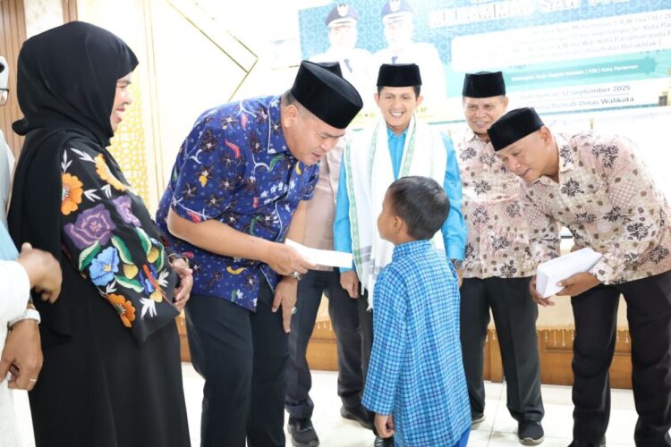 BANTUAN INFAK—Wali Kota Pariaman, Yota Balad menyerahkan infak dari Guru dan Tenaga Kependidikan (GTK) kepada 80 orang murid Sekolah Dasar (SD) se Kota Pariaman di Balairung Pendopo Walikota Pariaman, Jumat (12/9).