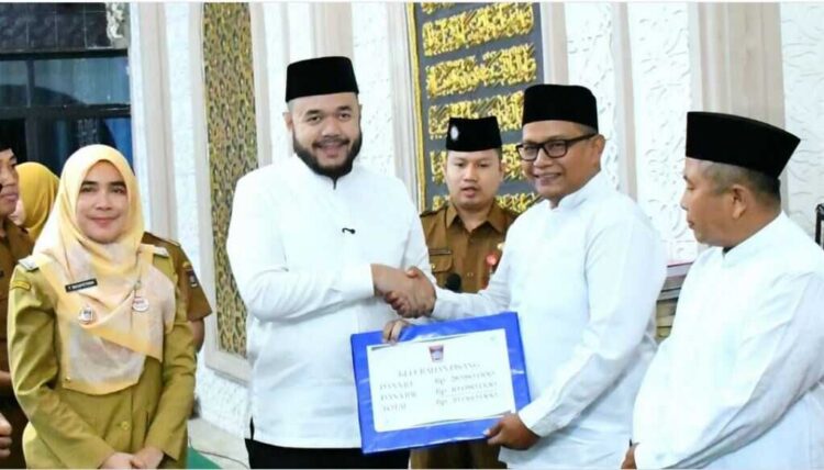 PENYERAHAN DANA INSENTIF— Wako Fadly Amran, menyerahkan dana dana operasional triwulan III tahun 2025 senilai lebih dari Rp724 juta untuk insentif Ketua RT/RW, guru mengaji, imam masjid, dan guru PAUD saat kegiatan Subuh Mubarakah dan implementasi program strategis Smart Surau di Masjid Raya Pauh, Senin (20/10).