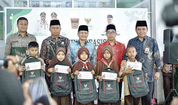 PENYERAHAN BEASISWA— Siswa dan siswi SD/MI penerima beasiswa Baznas Kota Padang berfoto bersama dengan Ketua Baznas Kota Padang Yuspardi, Kepala Kemenag Edy Oktafiandi, Kabag Kesra Jasman, Kepala Disdikbud Yopi Krislova dan Baznas Provinsi Sumatera Barat Nurman Agus.