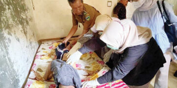 GANTUNG DIRI— Jenazah Zainal (59) diperiksa oleh petugas medis usai ditemukan tewas tergantung dalam rumahnya di Kampung Koto VIII Hilir, Nagari Koto VIII Pelangai, Kecamatan Ranah Pesisir.